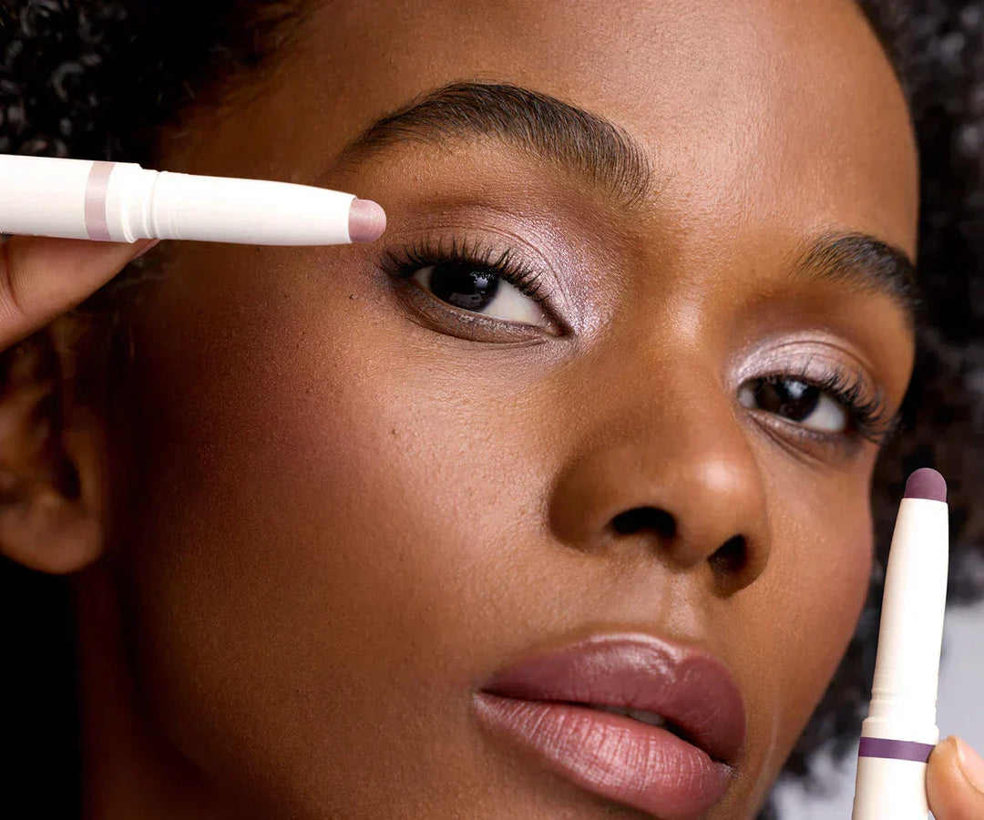 Model wearing and holding ColorLuxe Eye Shadow Stick in shade Prima and Provence