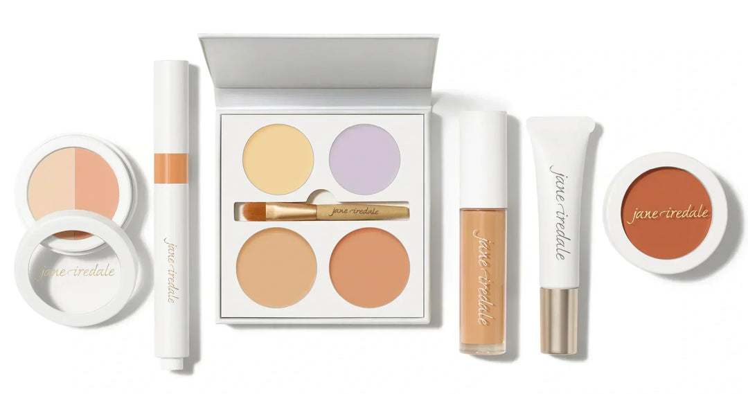 Collection of Jane Iredale concealer makeup products lying side by side, on a white background.