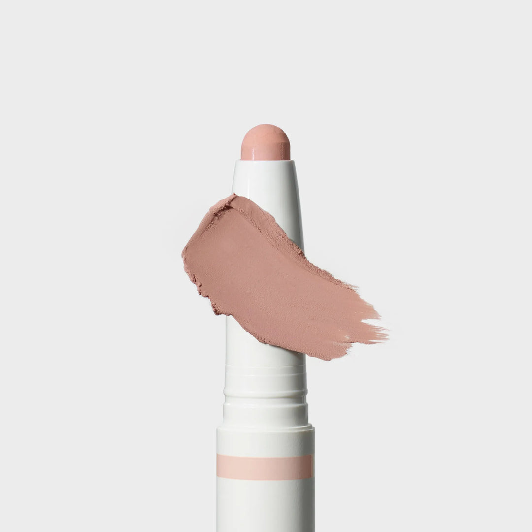 Jane Iredale® ColorLuxe Eye Shadow Stick in Cameo, shown in a white twist-up tube with the cream shadow bullet extended and a soft matte cool pink swipe across the front.