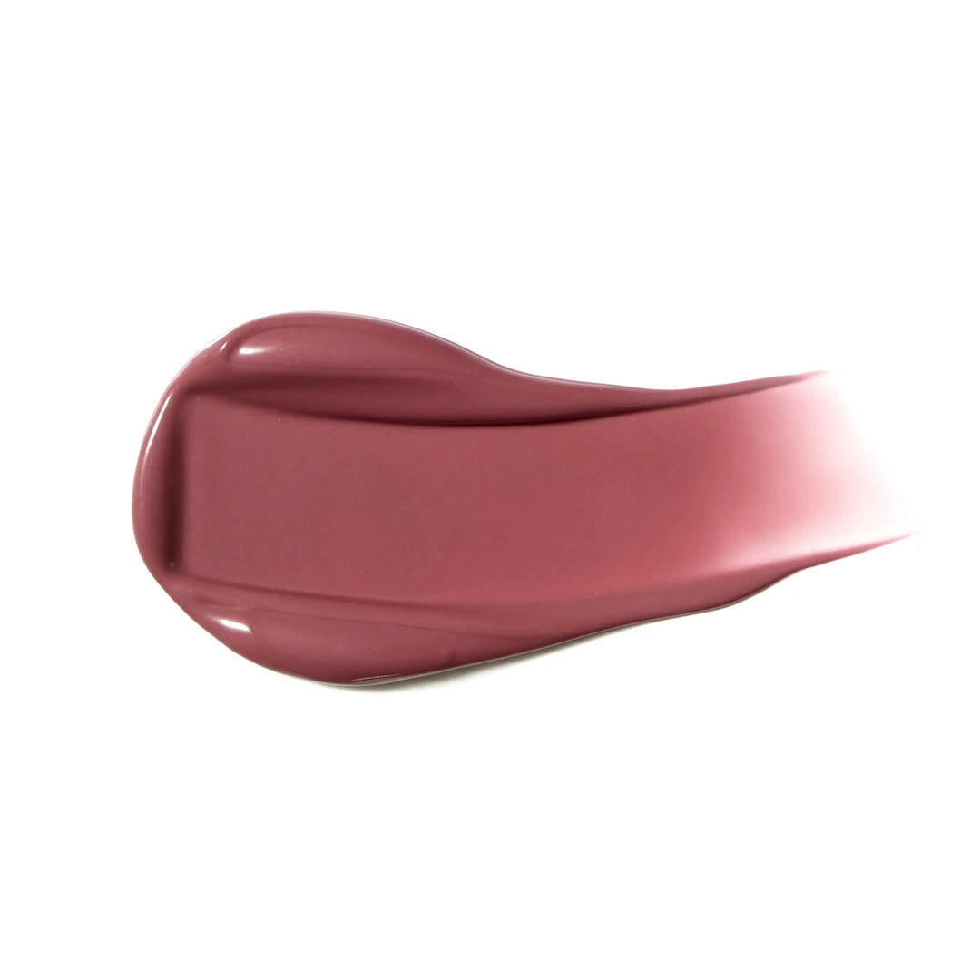Swoosh of mauve coloured liquid blush on white background