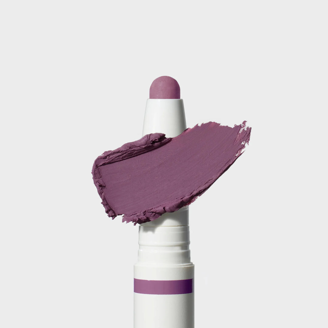Jane Iredale® ColorLuxe Eye Shadow Stick in Provence, shown in a white twist-up tube with the cream shadow bullet extended and a matte medium purple swipe across the front.