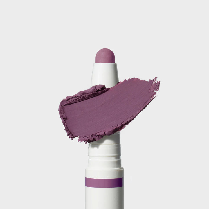 Jane Iredale® ColorLuxe Eye Shadow Stick in Provence, shown in a white twist-up tube with the cream shadow bullet extended and a matte medium purple swipe across the front.