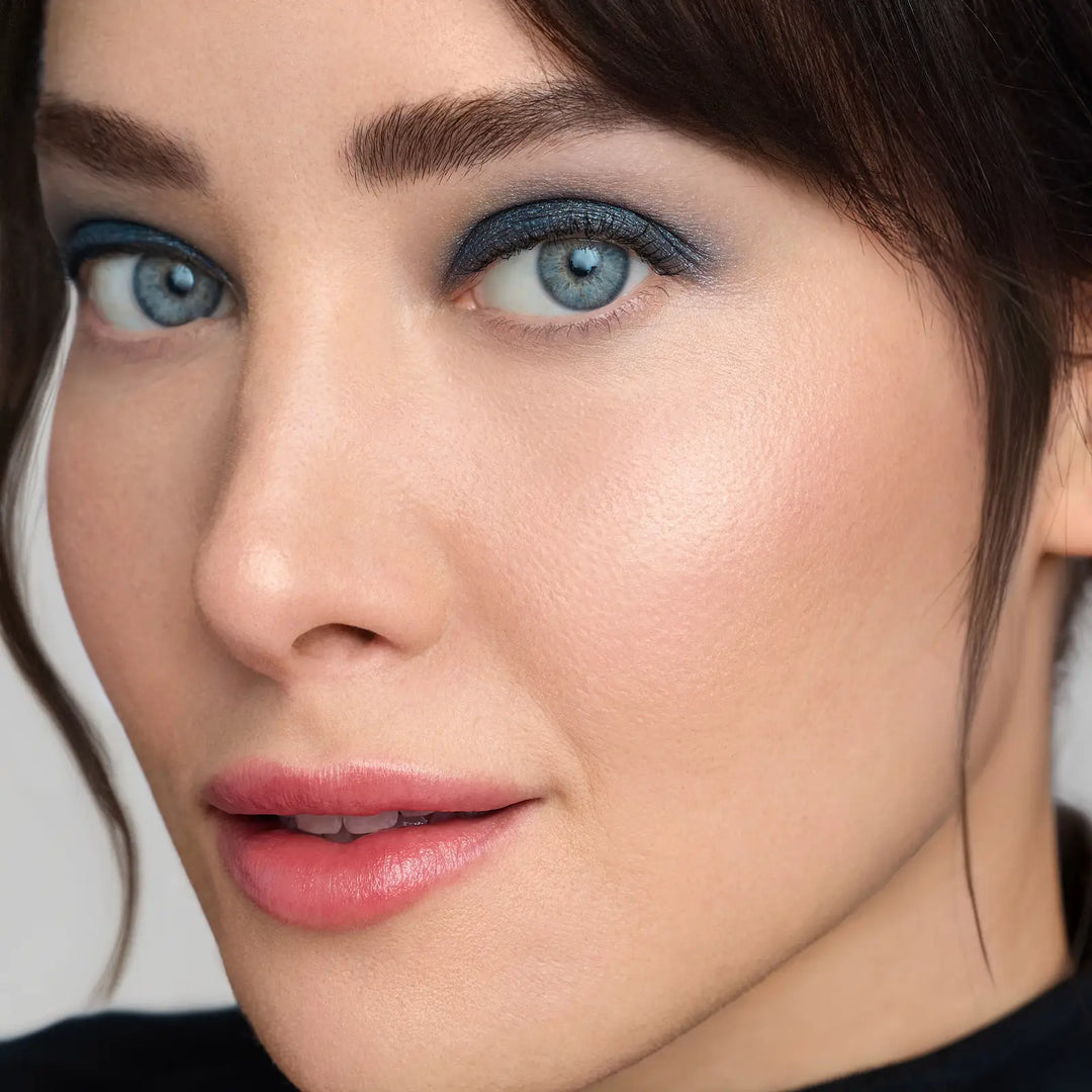 Close-up of a woman's face with Riviera ColorLuxe Eye Shadow stick applied, and Rosebud lipstick - a warm medium pink brown lipstick shade