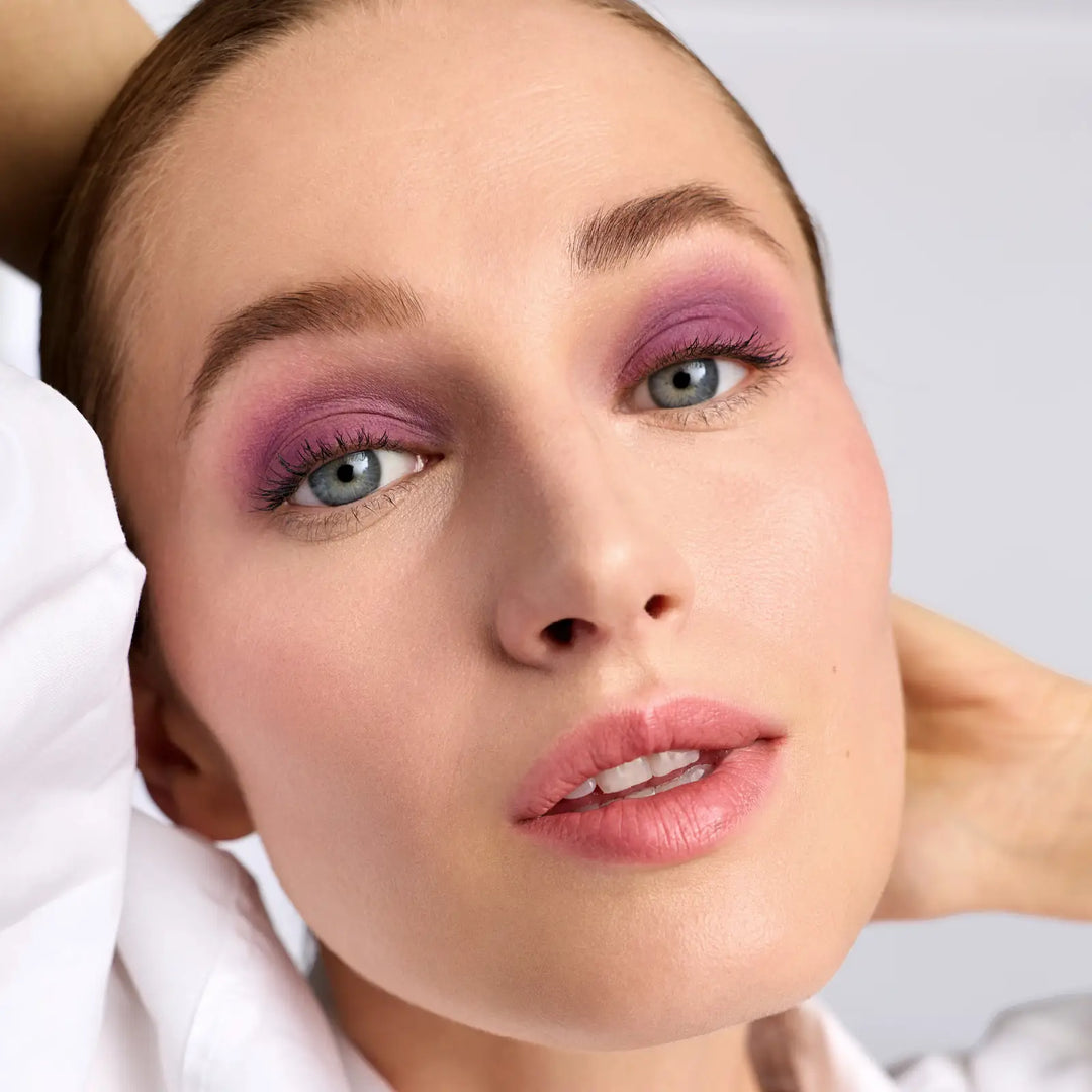Close-up of a woman wearing the vibrant Provence ColorLuxe Eye Shadow Stick - a medium purple matte.