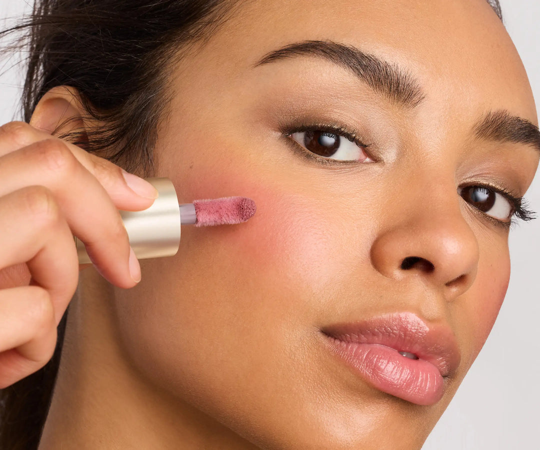 Jane Iredale model applying ColorLuxe Liquid Blush to the apple of her cheek