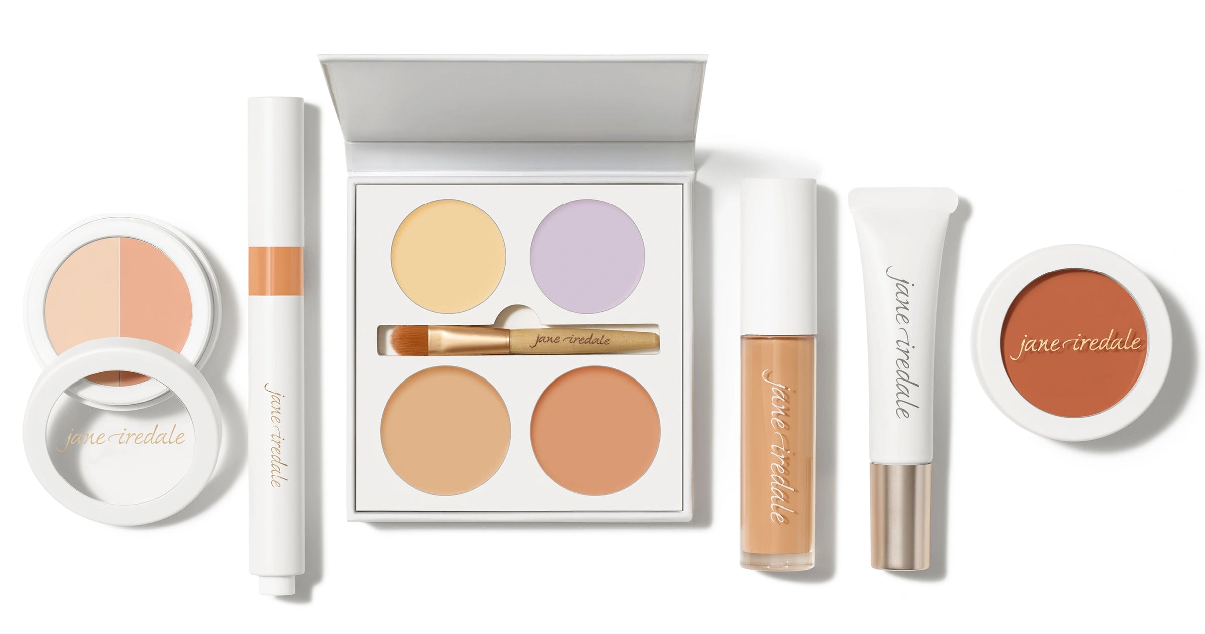 Collection of Jane Iredale concealer makeup products on a white background.